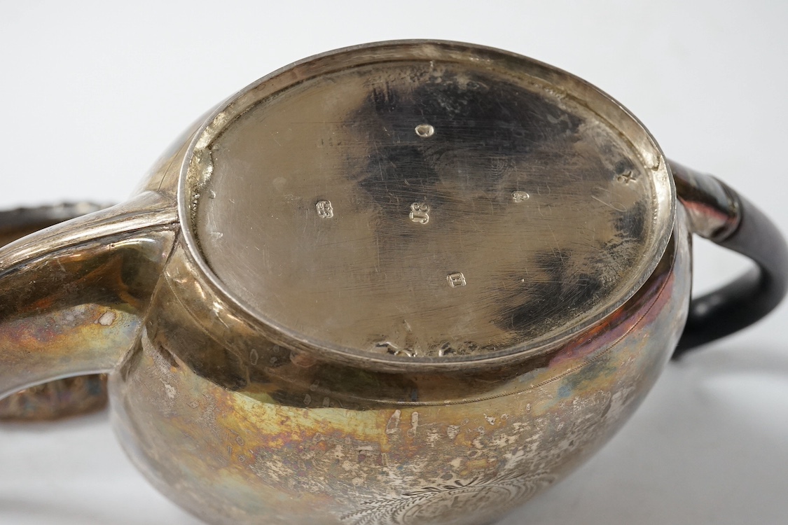 A George III engraved silver oval teapot, by John Eames, London, 1803, together with an early Victorian engraved silver milk jug, Edward Barton, London, 1837 and a late Victorian embossed silver sugar bowl by Josiah Will